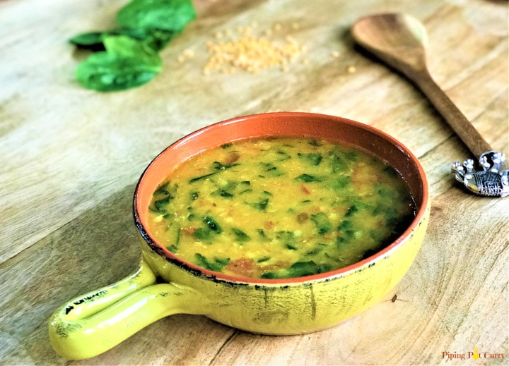 Lentils with spinach made in Instant Pot served in a yellow bowl (Pressure Cooker Dal Palak)