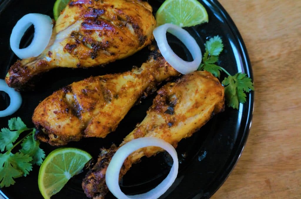 A flavor packed spicy dish from the Indian subcontinent popular all over the world - Tandoori Chicken. Chicken is marinated in yogurt, ginger, garlic, spices and lemon juice, then grilled in the air fryer or oven. A flavor packed spicy dish from the Indian subcontinent popular all over the world. Chicken is marinated in yogurt, ginger, garlic, spices and lemon juice, then grilled in the air fryer or oven.