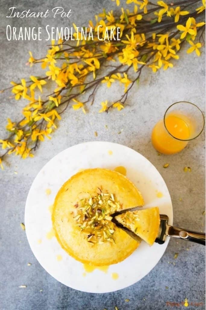 Semolina Cake / Rava Cake topped with orange syrup made in Instant Pot or Pressure Cooker. An easy to make, fluffy and moist cake with the gorgeous orange flavor. This is a egg free and flour free cake perfect for vegetarians | #cake #semolinacake #farina #orangecake #revani #basbousa | pipingpotcurry.com