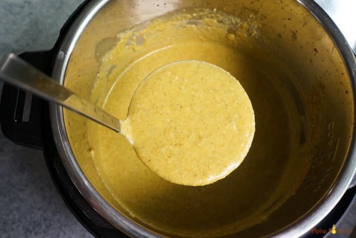 Enjoy this healthy Instant Pot Cream of Broccoli soup made in less than 30 minutes. This amazing comfort food can be enjoyed guilt free now, with this plant based vegan & gluten free recipe. Instant Pot Broccoli Soup Ready - a ladle filled from the instant pot