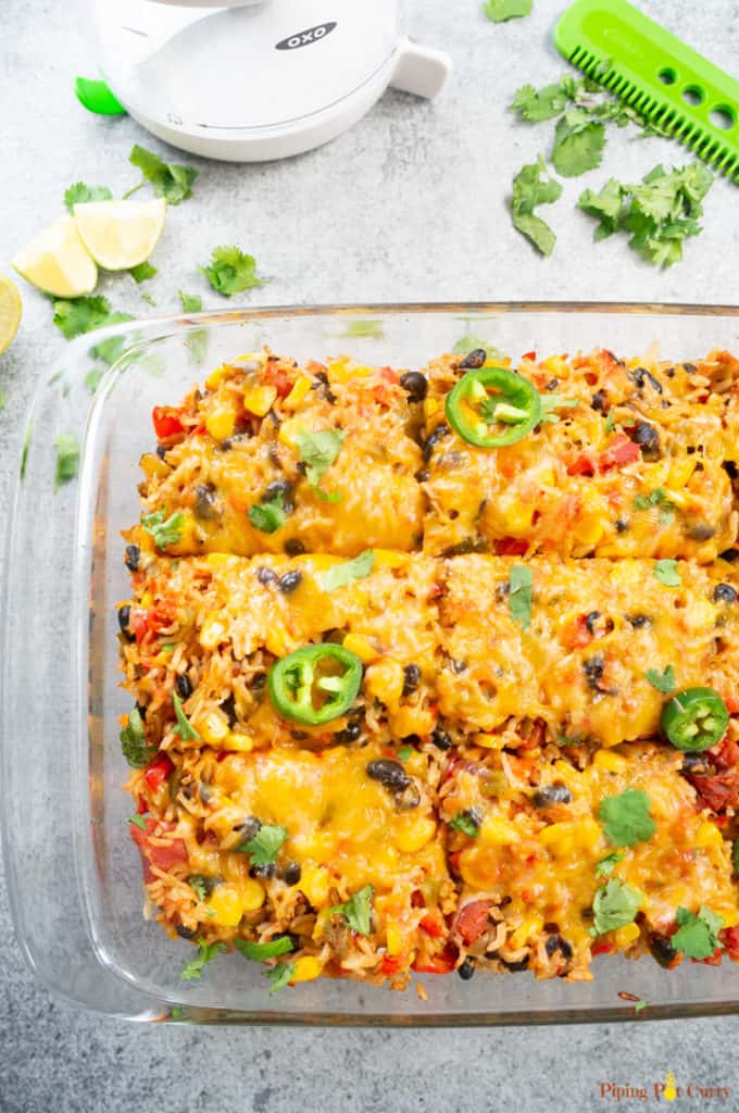 Vegetarian Mexican Casserole with Rice & Beans - Baked and cut into pieces to serve. Lime, cilantro to garnish.