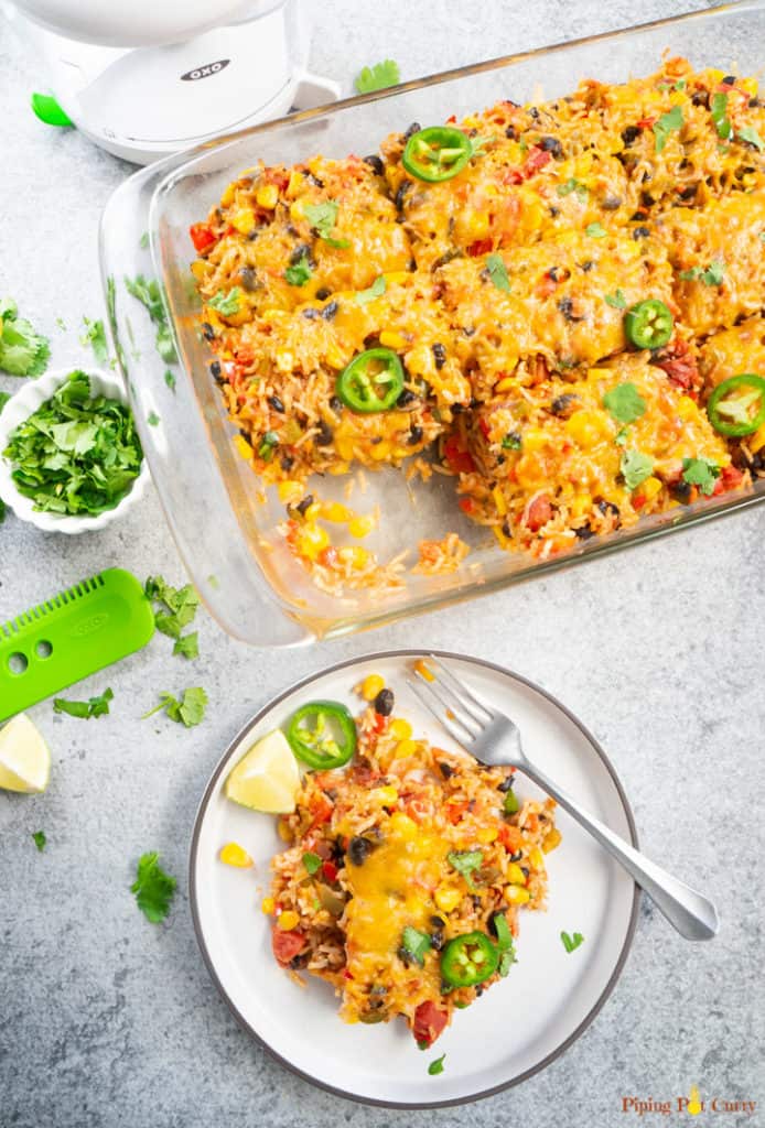 Vegetarian Mexican Casserole with Rice & Beans served on a white plate along with a fork.
