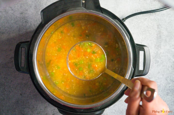 Easy & comforting Instant Pot Sweet Corn Soup. This lightly spiced Indo-chinese soup is perfect for the cold weather. This is a vegan & gluten free soup! A ladle full of Sweet Corn Soup made in the Instant Pot