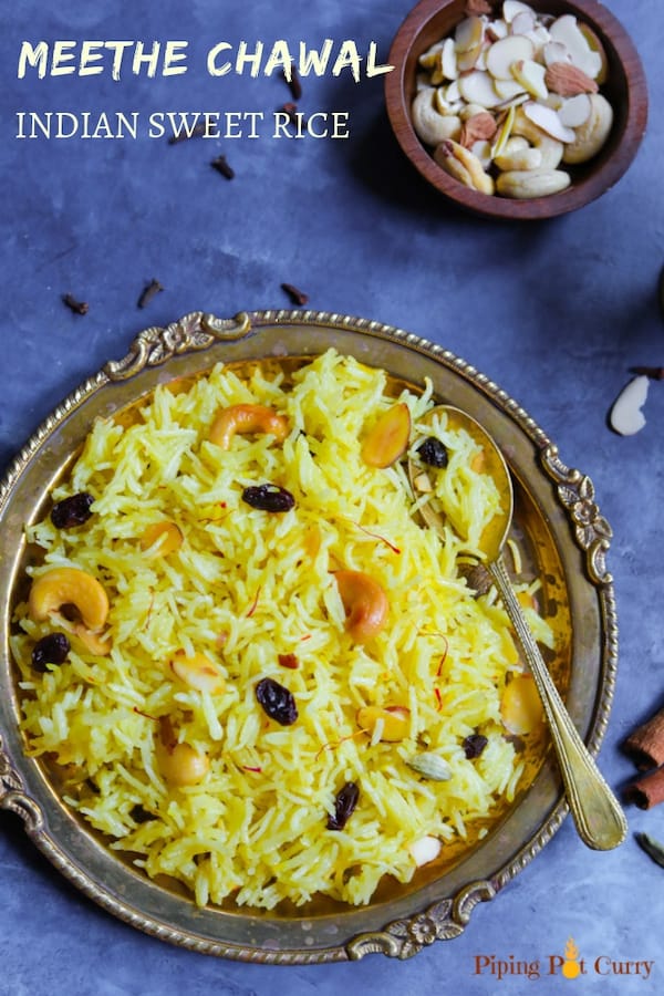 Meethe Chawal or Zarda Rice is a sweet and rich rice preparation loaded with dry fruits, sugar and ghee. This aromatic sweet saffron flavored rice is a royal dessert made on special occasions and festivals | #zarda #sweetrice #chawal #rice #dessert #glutenfree #vegetarian #pipingpotcurry | pipingpotcurry.com Zarda Rice made in instant pot served on a plate