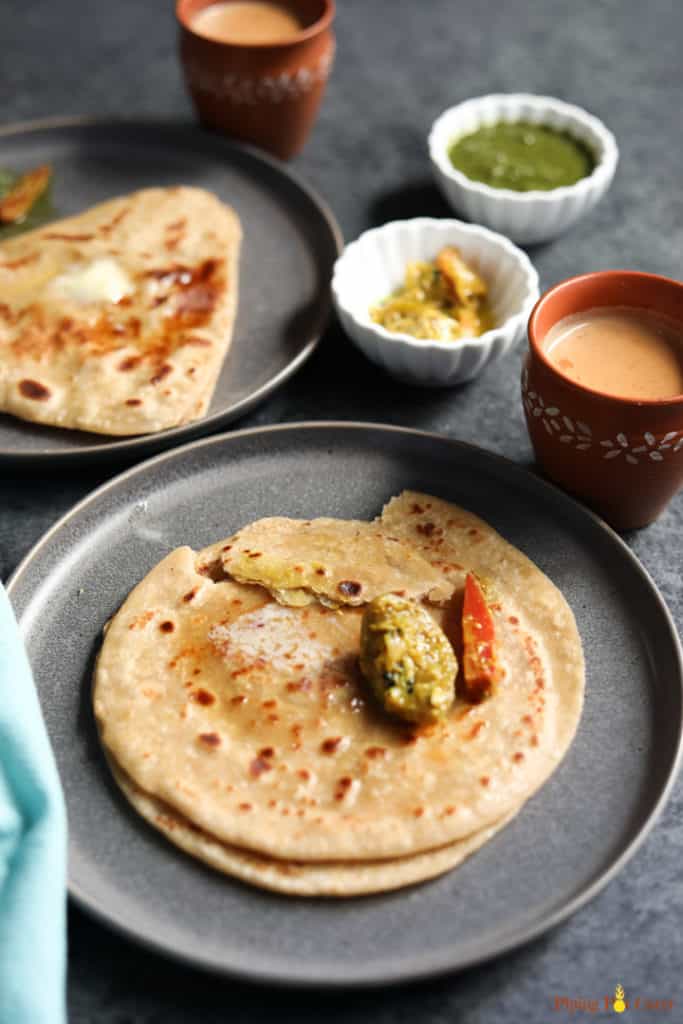 Learn the tips and tricks to make perfect soft and flaky parathas at home every time. This pan-fried Indian flatbread is perfect to enjoy with pickle, yogurt or a curry | #breakfast #paratha #indianfood #pipingpotcurry #indianbread | pipingpotcurry.com Paratha. Indian flatbread - Piping Pot Curry