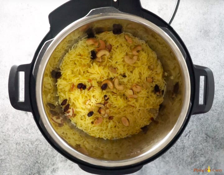 Meethe Chawal or Zarda Rice is a sweet and rich rice preparation loaded with dry fruits, sugar and ghee. This aromatic sweet saffron flavored rice is a royal dessert made on special occasions and festivals | #zarda #sweetrice #chawal #rice #dessert #glutenfree #vegetarian #pipingpotcurry | pipingpotcurry.com Zarda. Meethe Chawal - Ready in Instant Pot