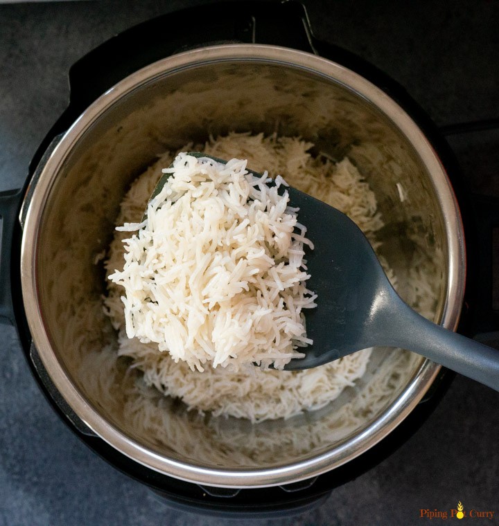 Fast & Easy Pressure Cooker Coconut Rice - Perfectly cooked rice with the sweet aroma and subtle flavor of coconut milk. A great vegan & gluten free side dish to many Asian dishes! Coconut Rice cooked in pressure cooker topped with coconut flakes
