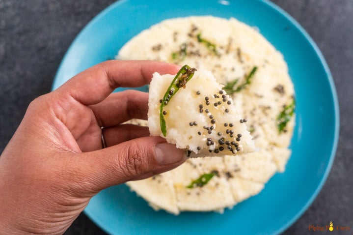 Closeup of a piece of Rava Dhokla steamed in a pressure cooker