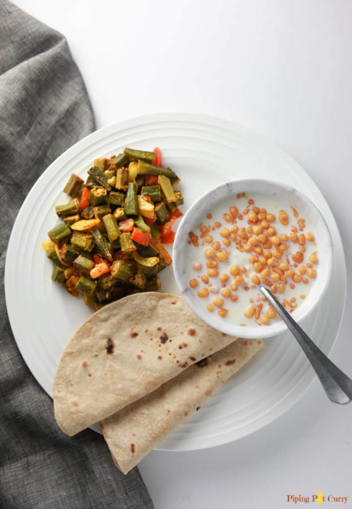Oven Roasted Okra (Baked Bhindi Masala) served with roti and raita.
