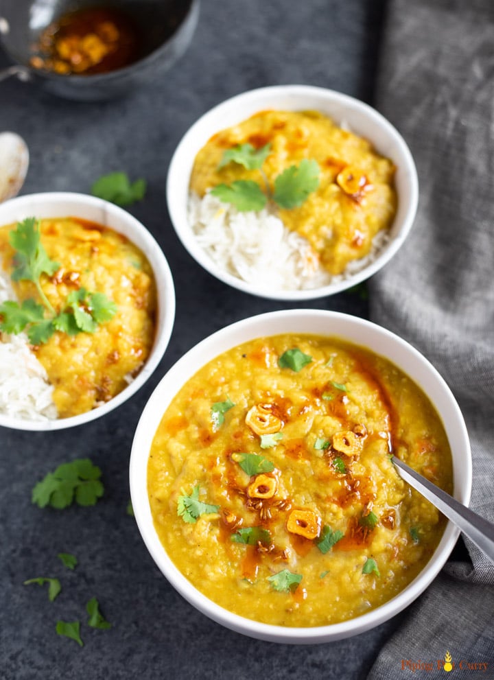 Red Lentils served in 3 bowls over rice and topped with cilantro