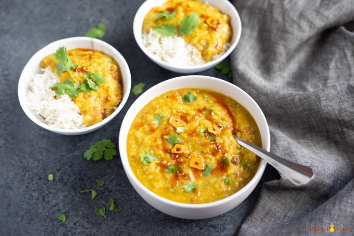 Red Lentils served in 3 bowls over rice and topped with cilantro