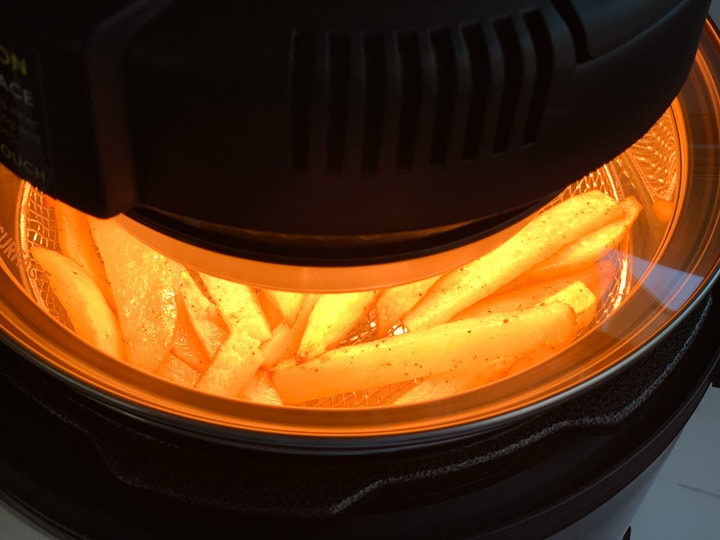 Fries cooking that can be seen from a glass lid